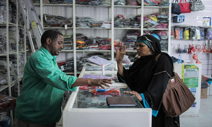 Storeowner and customer in Somalia.jpg